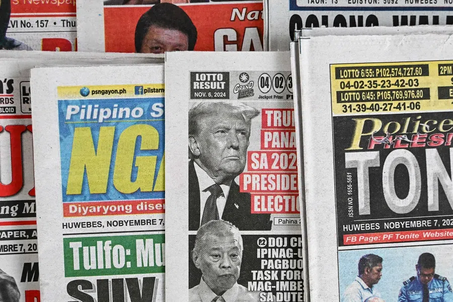 This photo illustration shows the front pages of the newspapers in Manila on 7 November 2024 showing the re-election of US President-elect Donald Trump. (Jam Sta Rosa/AFP)
