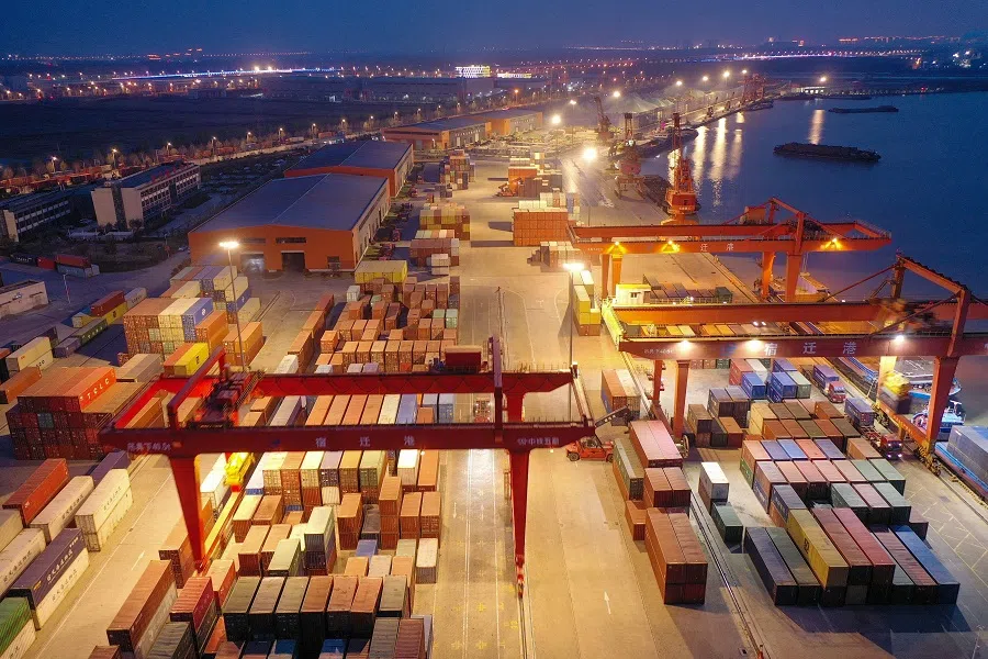 This aerial photo taken on 26 March 2023 shows shipping containers stacked at Suqian port in Jiangsu province, China. (AFP)