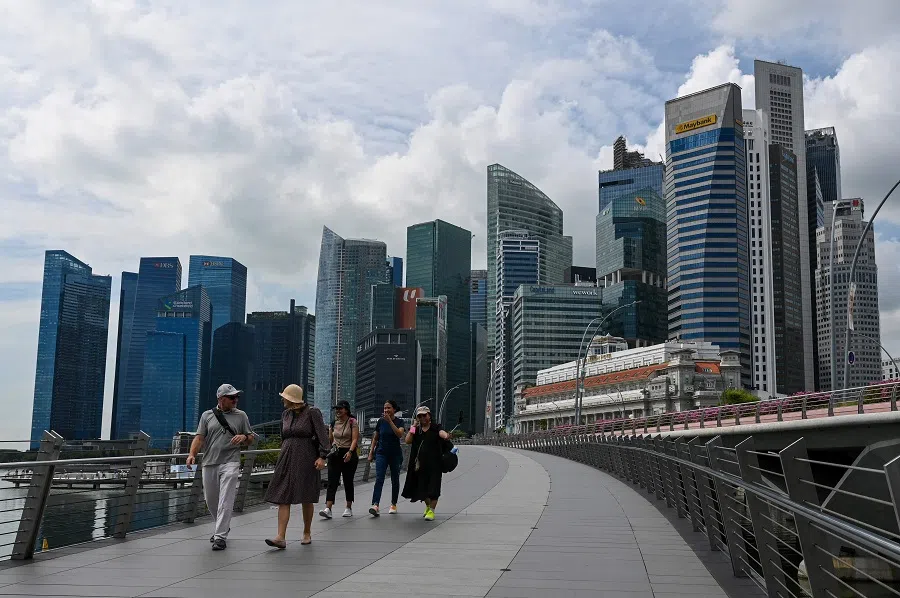 People walk over Jubilee Bridge at Marina Bay waterfront in Singapore on 17 November 2023. (Roslan Rahman/AFP)