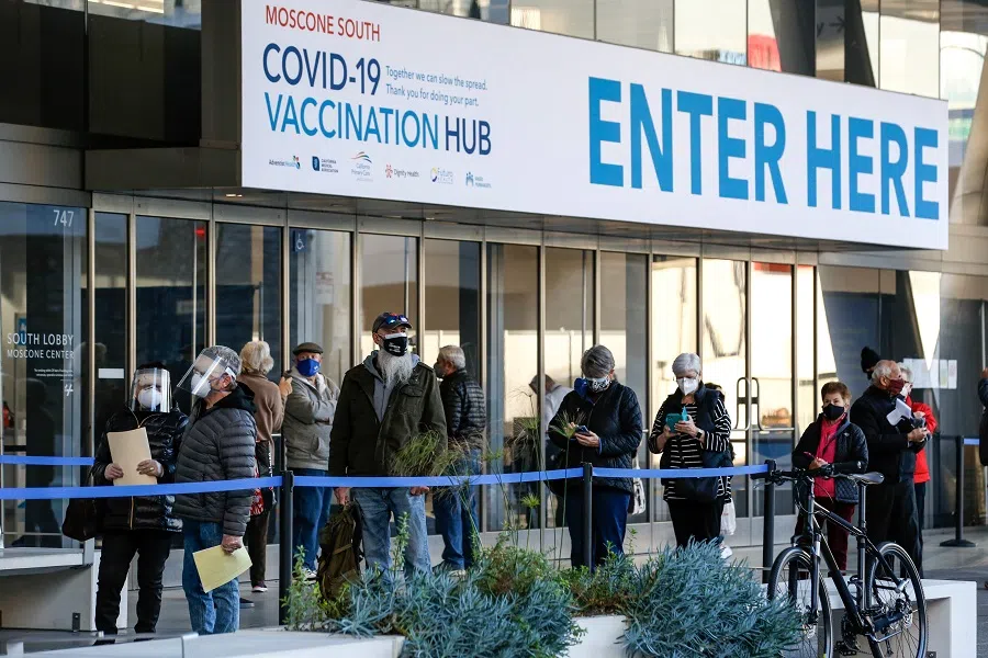 People stand in line at the mass vaccination site at San Francisco's Moscone Convention Center that opened today for healthcare workers and people over 65 on 5 February 2021 in San Francisco, California. (Amy Osborne/AFP)