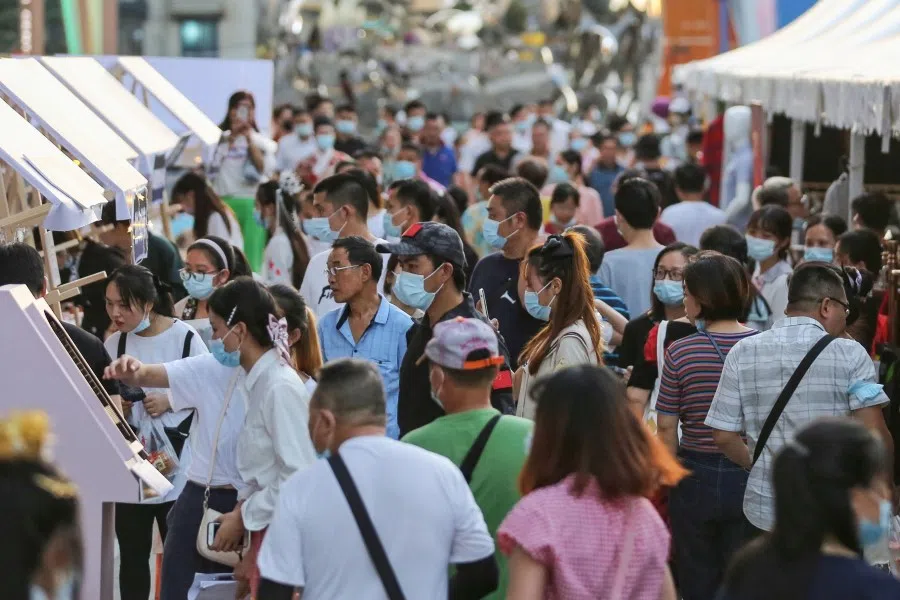 This photo taken on 27 August 2020 shows people visiting a night market in Wuhan in China's central Hubei province. (STR/AFP)