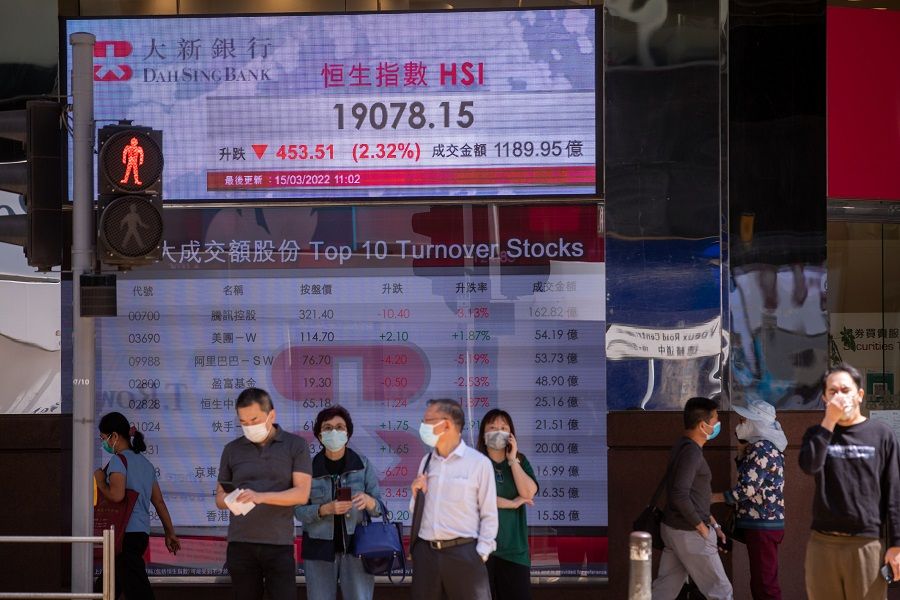 An electronic screen displays the Hang Seng Index, top, and stock figures for the top 10 turnover stocks in Hong Kong, China, on 15 March 2022. (Paul Yeung/Bloomberg)