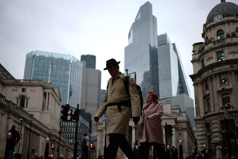 People walk past the Bank of England in the City of London financial district in London, Britain, on 13 February 2025.