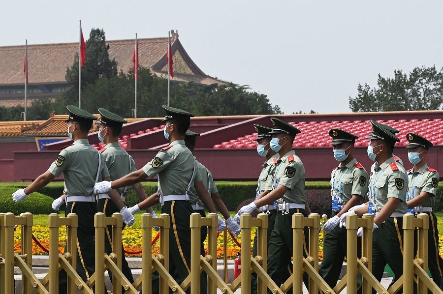 Paramilitary police officers patrol Tiananmen Square a day before an event marking the 100th anniversary of the founding of the Communist Party of China, in Beijing, China, on 30 June 2021. (Greg Baker/AFP)