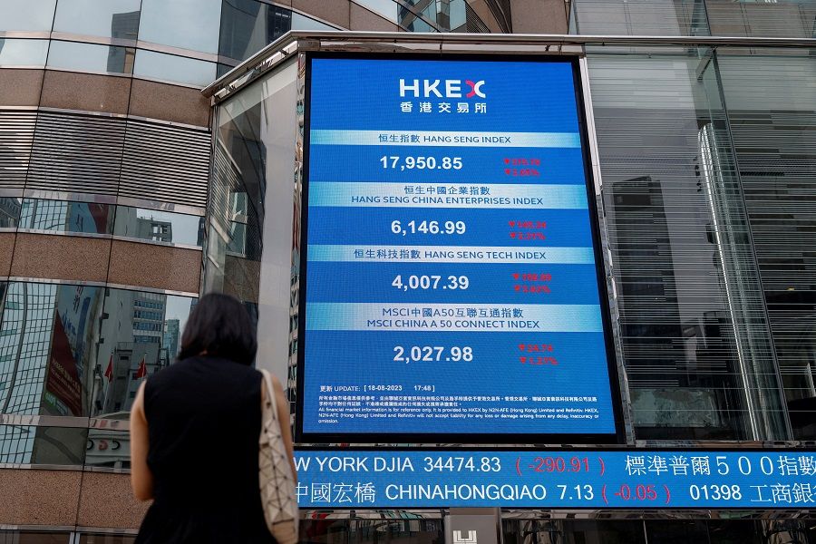 A screen showing the Hang Seng stock index is seen outside Exchange Square, in Hong Kong on 18 August 2023. (Tyrone Siu/Reuters)