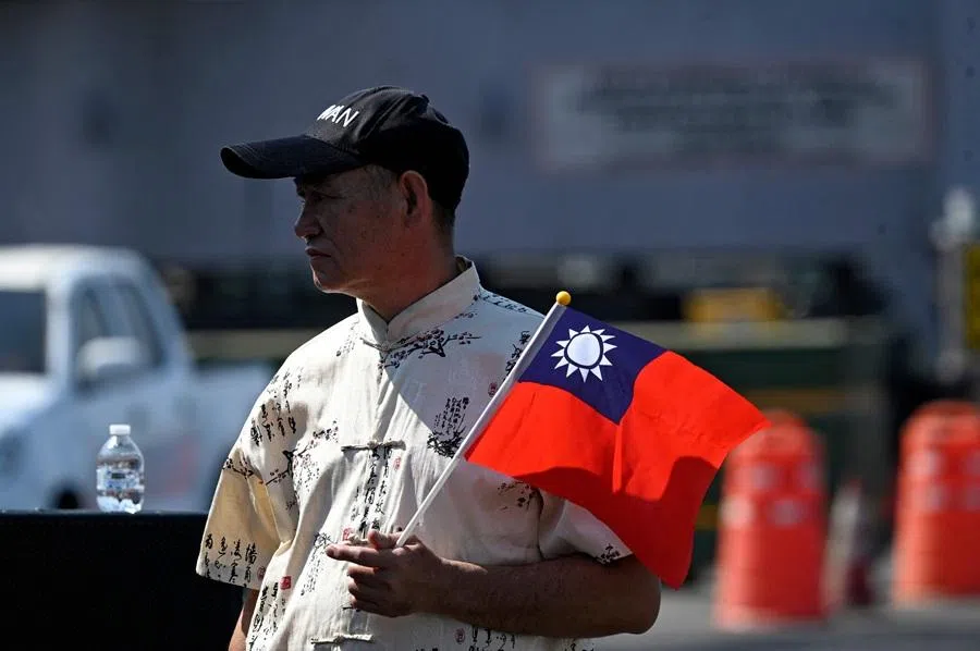 A man holds a Taiwanese flag after three Taiwanese Navy warships arrived at Puerto Quetzal, Guatemala, on 2 May 2026, as part of a naval squadron. (Johan Ordonez/AFP)