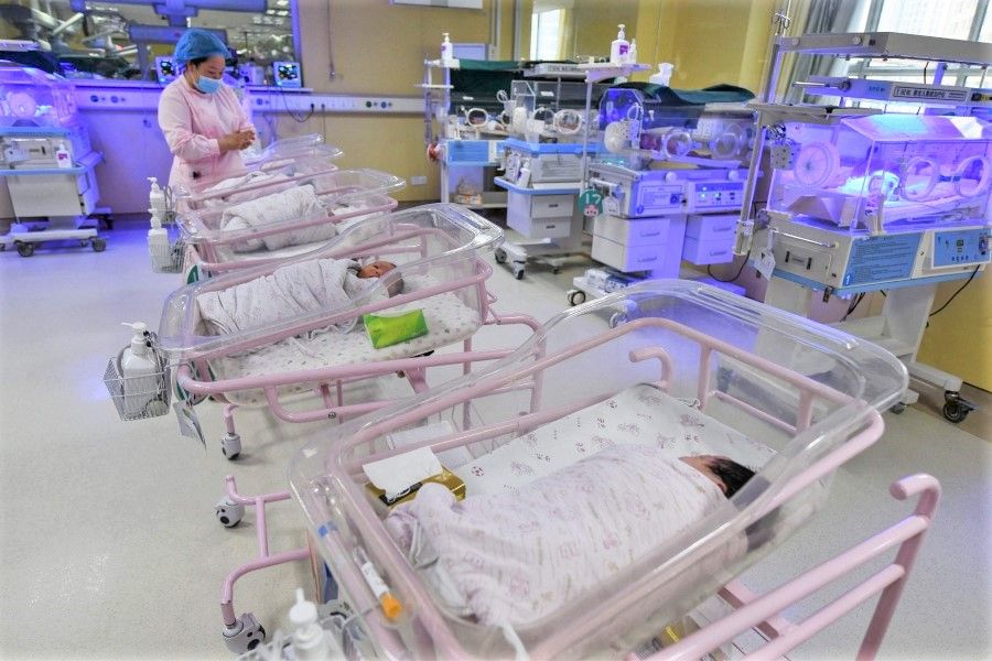 This file photo taken on 25 April 2021 shows a medical staff member taking care of a newborn baby in the paediatric ward of a hospital in Fuyang in China's eastern Anhui province. (AFP)