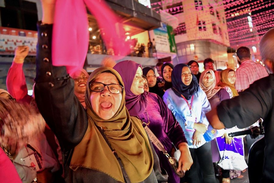 Supporters of Mohamed Muizzu shout slogans along a street in Male, Maldives, on 30 September 2023. (Mohamed Afrah/AFP)