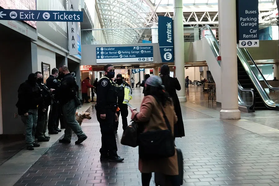 People walk through a nearly empty Union Station in Washington the day after the inauguration of Joe Biden as president on 21 January 2021 in Washington, DC. (Spencer Platt/Getty Images/AFP)