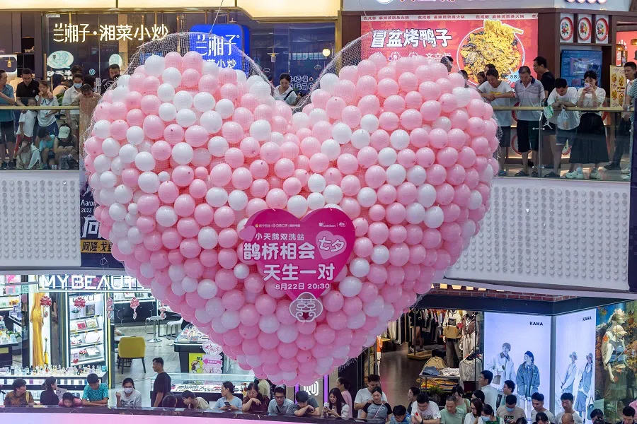 This photo shows people gathering to watch a blind date event which was held on the Qixi Festival, known as the traditional Chinese Valentine's Day, on 22 August 2023, in Zhengzhou, Henan Province. (Stringer/AFP)