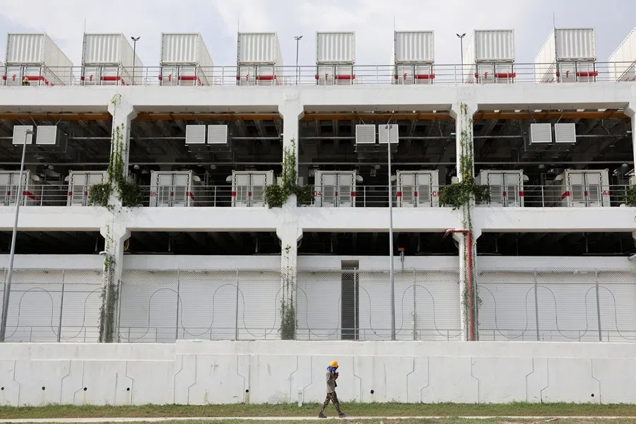 A worker walks past a data centre in Johor state, which has become Southeast Asia's fastest-growing data centre hub, at Gelang Patah, Malaysia, on 7 May 2026.