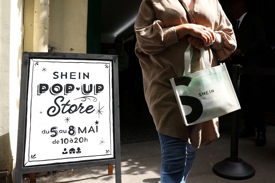 A woman leaves a pop-up store of Chinese fast-fashion retailer Shein in Paris, France, on 5 May 2023. (Johanna Geron/Reuters)