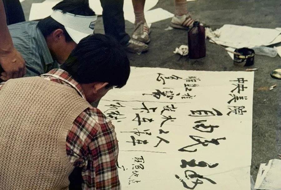 Students writing large-character posters.
