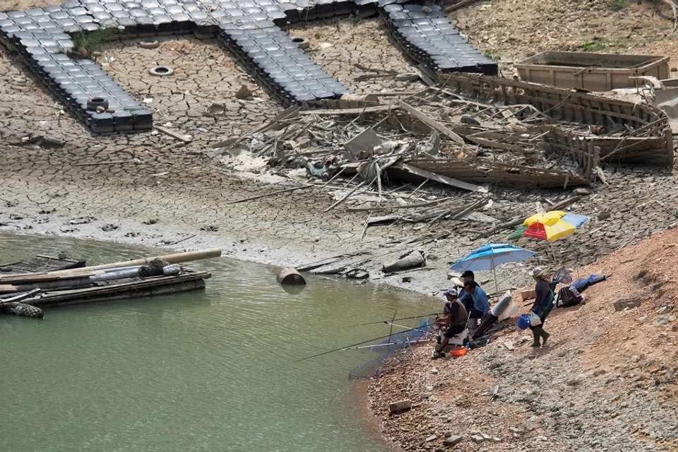 People fish at the Sun Moon Lake amid low water levels during an islandwide drought in Nantou, Taiwan on 15 May 2021. (Annabelle Chih/Reuters)