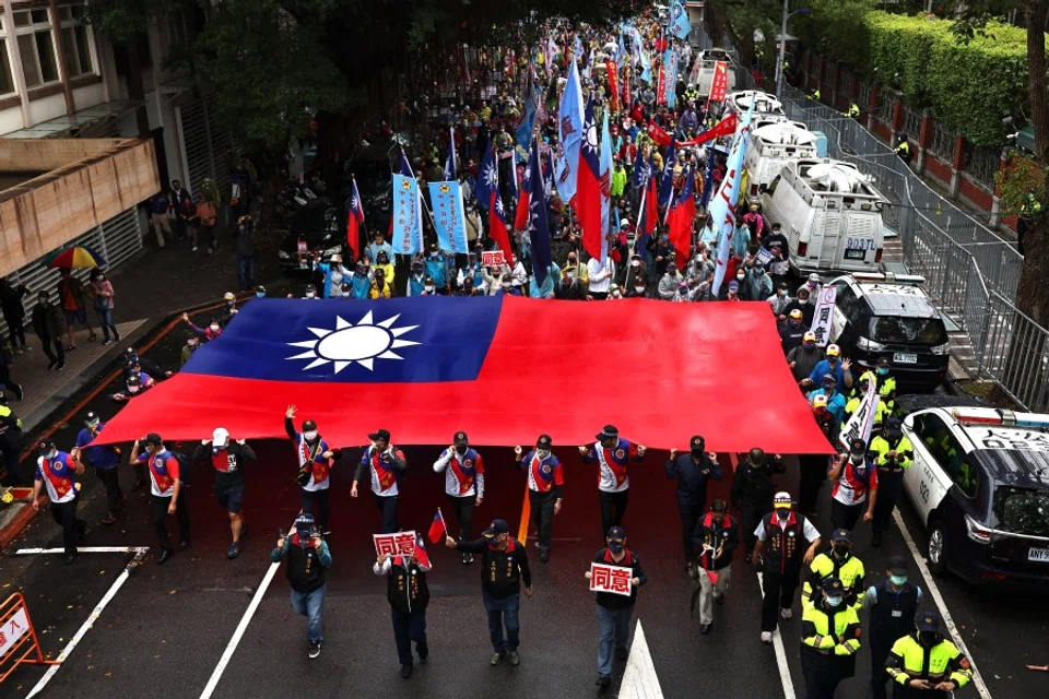 Supporters of Taiwan's main opposition party The Kuomintang (KMT) join the annual Autumn Struggle labor protest, focusing on its opposition to the government's decision to allow imports of US pork containing ractopamine, an additive that enhances leanness, and other issues related to the referendum in Taipei, Taiwan, 12 December 2021. (Ann Wang/Reuters)