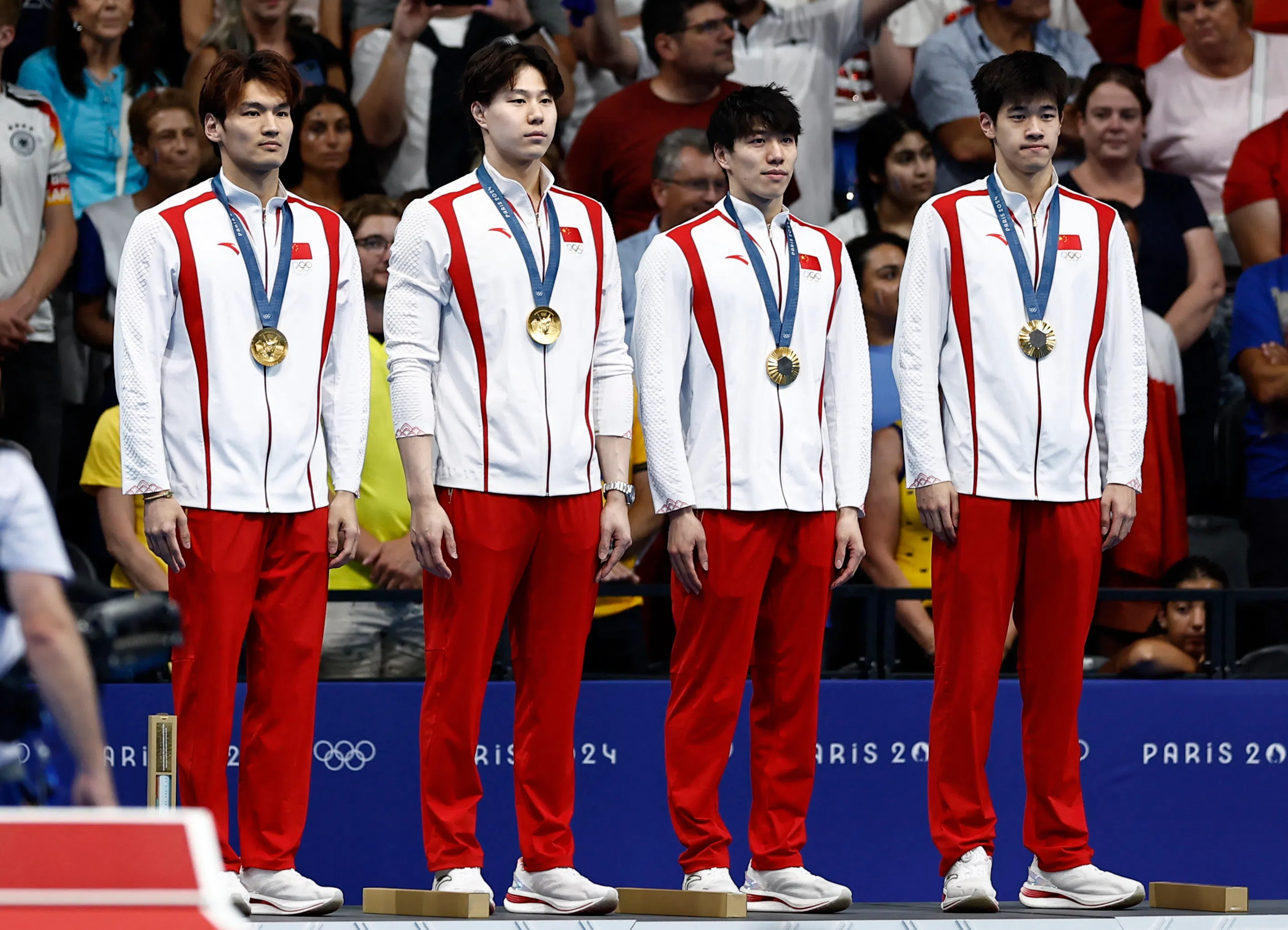Gold medallists Jiayu Xu of China, Haiyang Qin of China, Jiajun Sun of China and Zhanle Pan of China celebrate on the podium after winning the men’s 4x100m medley relay at the Paris 2024 Olympics, on 4 August 2024. (Clodagh Kilcoyne/Reuters)