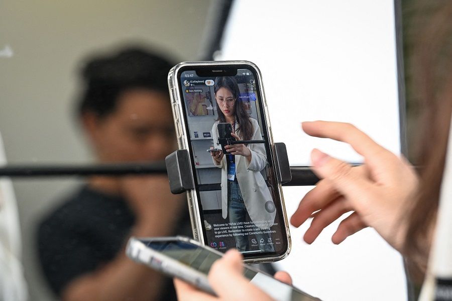 The photo taken on 2 April 2024 shows an instructor preparing to livestream on TikTok at Mede Education Technology’s e-commerce school in Guangzhou, China. (Jade Gao/AFP)