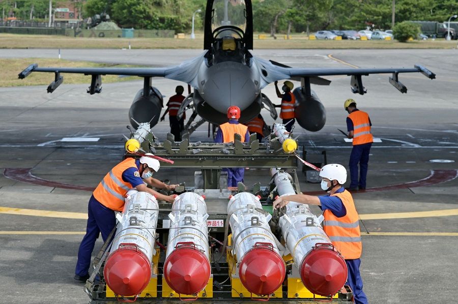 Air Force soldiers prepare to load US-made Harpoon AGM-84 anti-ship missiles in front of an F-16V fighter jet during a drill at Hualien Air Force Base in Taiwan on 17 August 2022. (Sam Yeh/AFP)