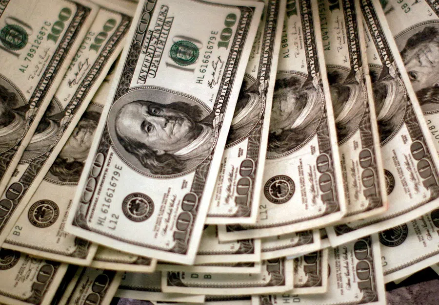 Four thousand US dollars are counted out by a banker counting currency at a bank in Westminster, Colorado, 3 November 2009. (Reuters/Rick Wilking)