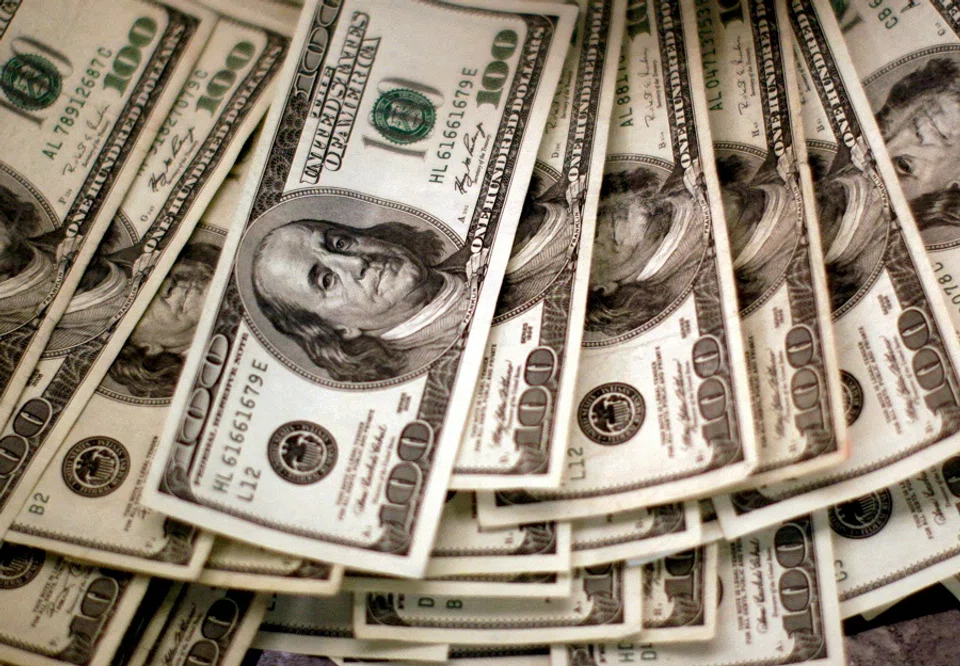 Four thousand US dollars are counted out by a banker counting currency at a bank in Westminster, Colorado, 3 November 2009. (Reuters/Rick Wilking)