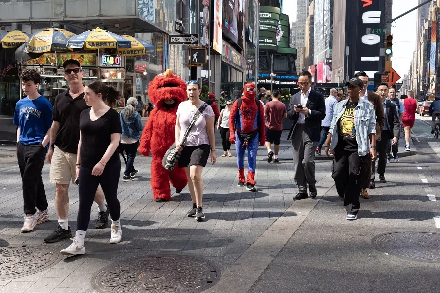 Pedestrians cross an intersection in Times Square in New York, US, on 13 April 2023. (Tim Eastman/Bloomberg)