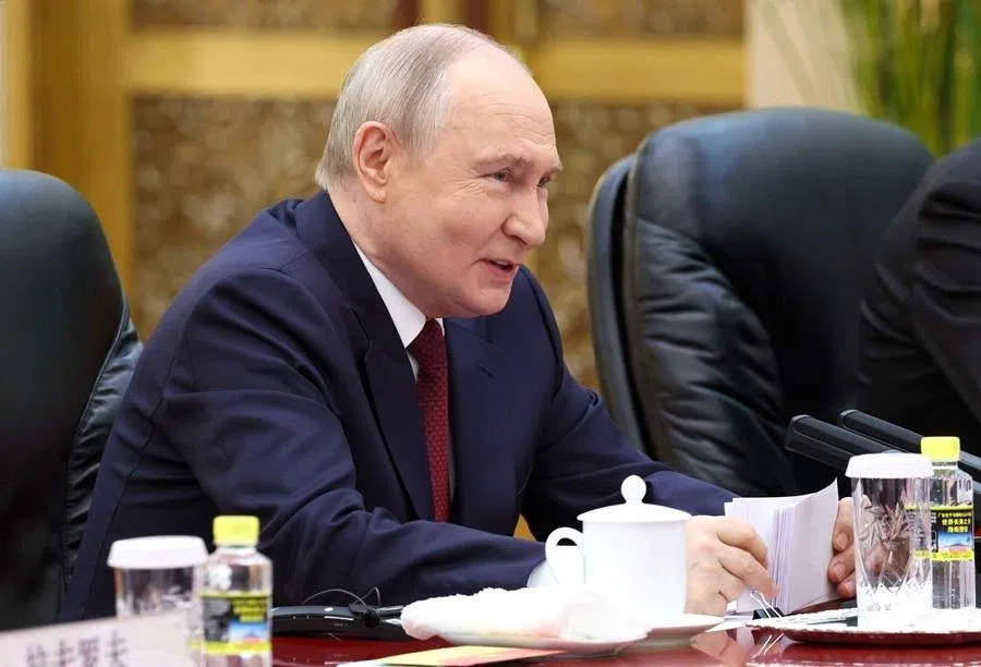 In this pool photograph distributed by the Russian state agency Sputnik, Russia's President Vladimir Putin takes part in a meeting with China's President Xi Jinping in Beijing on 20 May 2026. (Alexander Kazakov/Pool/AFP)