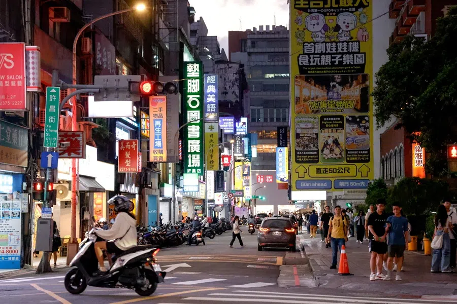 A motorbike drives past a street in Taipei, Taiwan, on 8 October 2025. (Ann Wang/Reuters)
