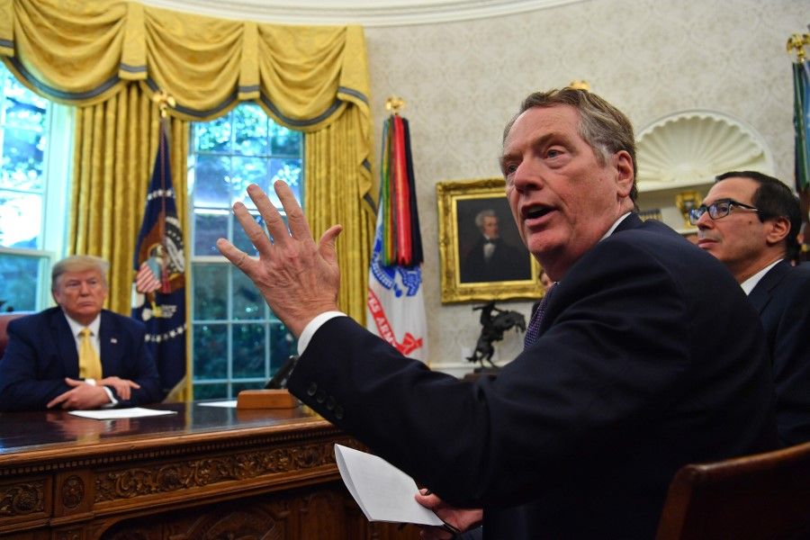 In this file photo taken on 11 October 2019, US Trade Representative Robert Lighthizer (centre) speaks to the press, alongside US Treasury Secretary Steven Mnuchin (right) and US President Donald Trump, after announcing and initial deal with China at the Oval Office of the White House in Washington. (Nicholas Kamm / AFP)