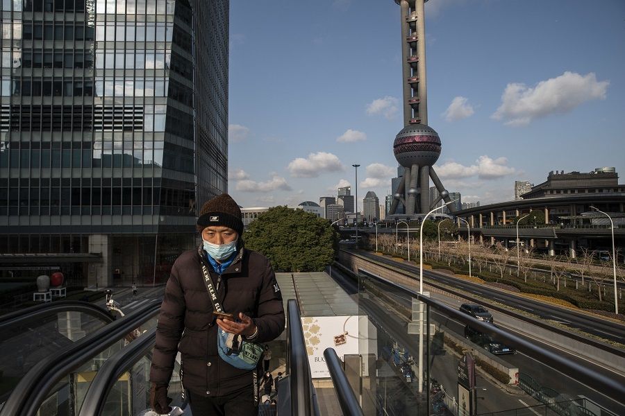 A pedestrian in Pudong's Lujiazui Financial District in Shanghai, China, on 3 January 2023. (Qilai Shen/Bloomberg)