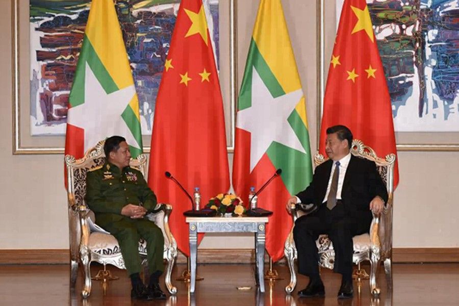 This handout photo taken and released on January 18, 2020 by the Office of the Commander-in-Chief of Defence Services shows Myanmar's army chief, Senior General Min Aung Hlaing (L) speaking with Chinese President Xi Jinping, during their meeting at a hotel in Naypyidaw. China supported Myanmar's military junta in the 1990s. (Handout/OFFICE OF THE COMMANDER-IN-CHIEF OF DEFENCE SERVICES/AFP)