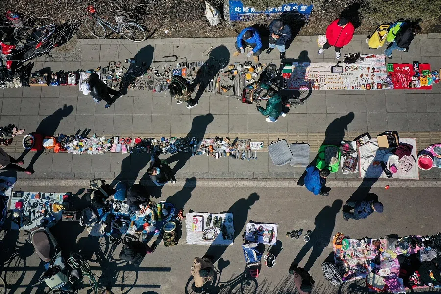 This photo taken on 17 March 2024 shows an aerial view of people browsing through items at a second-hand market in Shenyang, in northeastern China's Liaoning province. (AFP)