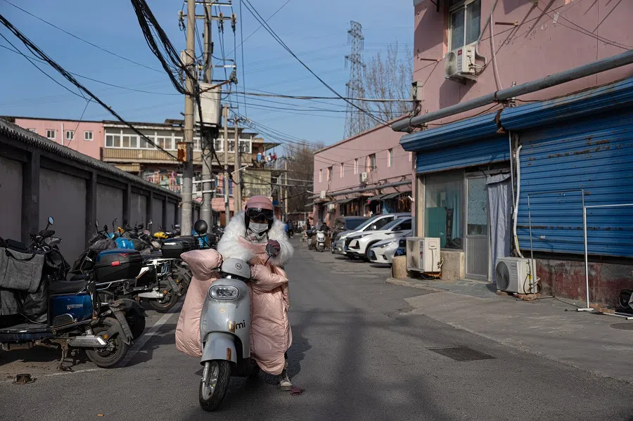 Sister Chen prepares to ride her electric bike to her first work location. Electric bikes are the most popular mode of transport for tenants here, as they are not subject to traffic jams, registration requirements, or restrictions on use, besides being cheap and convenient.
