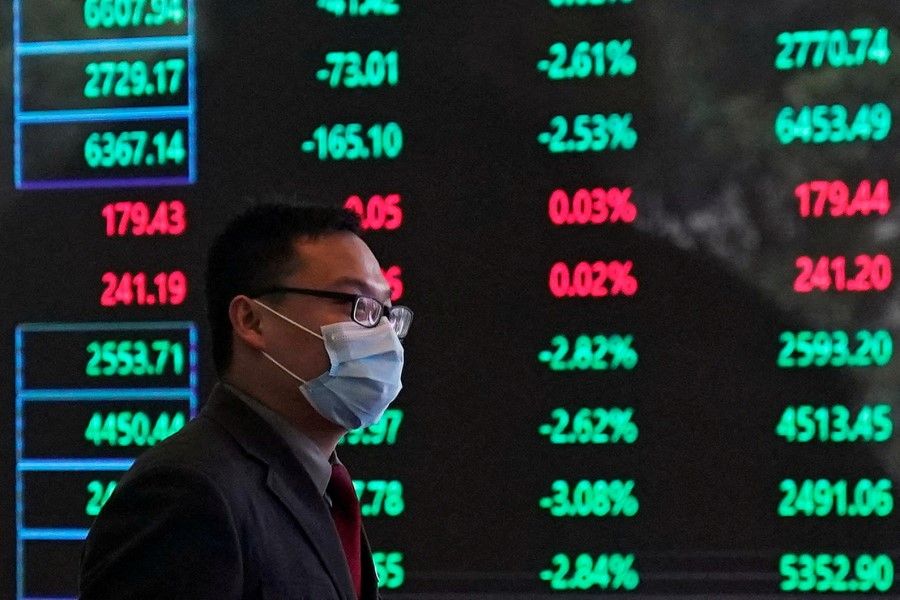 A man wearing a protective mask is seen inside the Shanghai Stock Exchange building at the Pudong financial district in Shanghai, China, 28 February 2020. (Aly Song/Reuters)