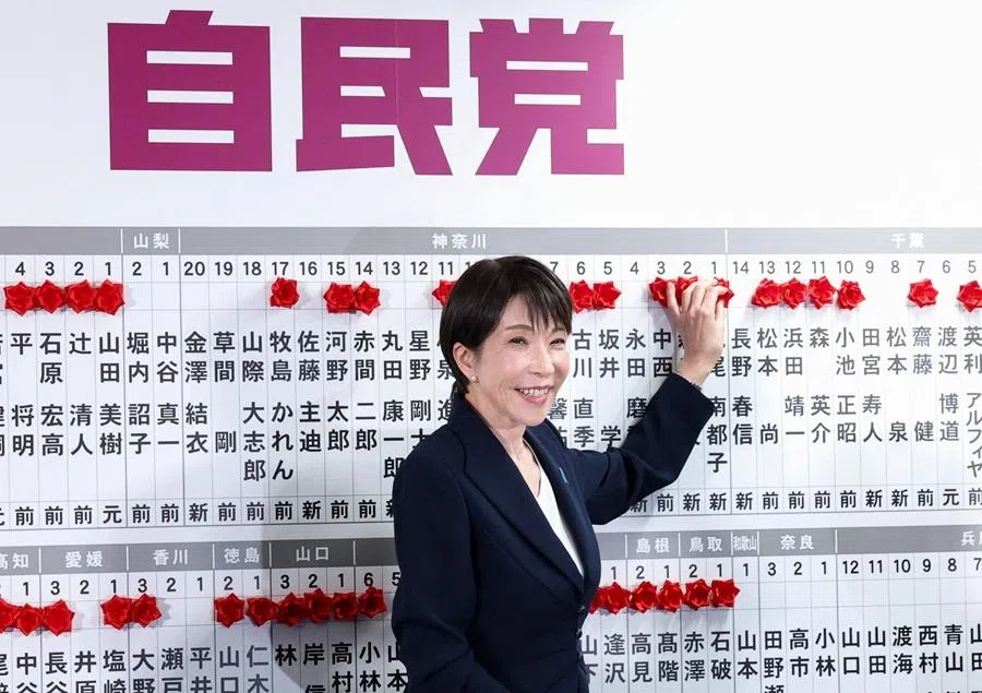 Japan's Prime Minister Sanae Takaichi, leader of the ruling Liberal Democratic Party (LDP), places a red paper rose on the name of an elected candidate at the LDP headquarters on general election day in Tokyo, Japan, on 8 February 2026. (Kim Kyung-Hoon/Reuters)