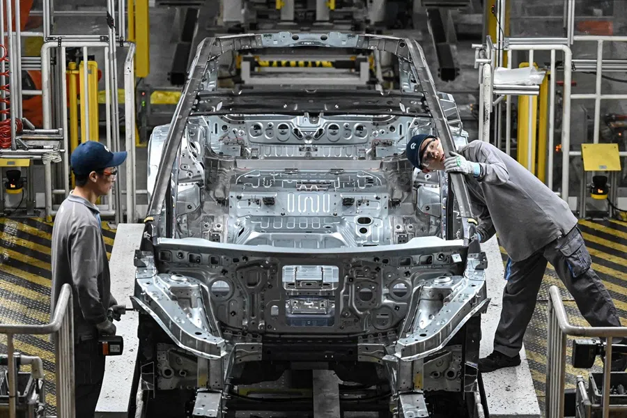 Employees work on an electric vehicle production line at a factory of Chinese automaker NIO in Hefei, in eastern China's Anhui province on 24 September 2025.