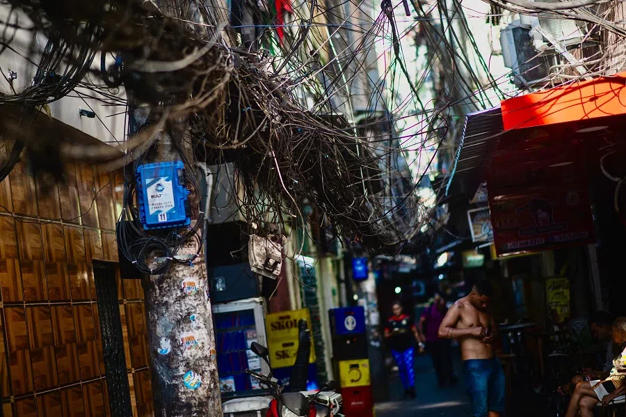 A pole with illegal power and telephone connections is pictured in an alleyway on the Rocinha favela, Rio de Janeiro, Brazil, on 18 November 2024. (Tercio Teixeira/AFP)