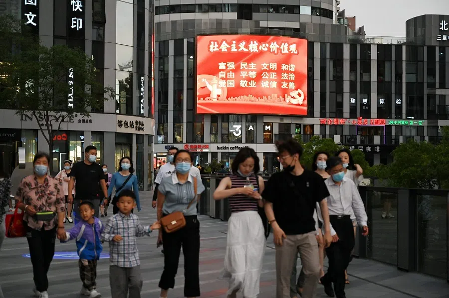 In this photo taken on 2 June 2021, a large screen shows a propaganda slogan which reads "Core socialist values: prosperity, democracy, civility, harmony, freedom, equality, justice, rule of law, patriotism, dedication, integrity, friendship", at a shopping mall in Beijing, China. (Greg Baker/AFP)