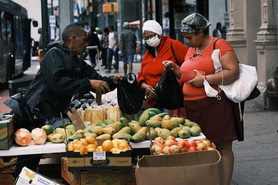 People shop in the Washington Heights neighbourhood in Manhattan on 11 June 2021 in New York City, US. (Spencer Platt/Getty Images/AFP)