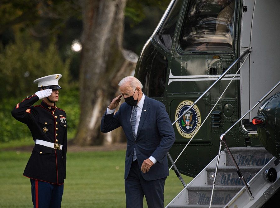 US President Joe Biden salutes as he returns to the White House in Washington, DC, on 25 October 2021. (Nicholas Kamm/AFP)