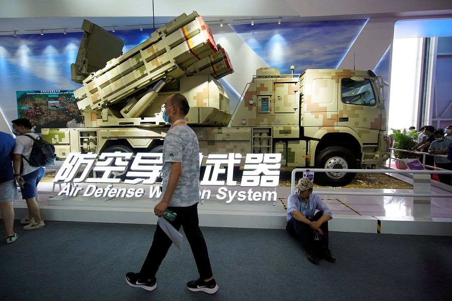 A man walks past a model of LY-70 air defense missile weapon system displayed at the China International Aviation and Aerospace Exhibition, or Airshow China, in Zhuhai, Guangdong province, China, 29 September 2021. (Aly Song/Reuters)