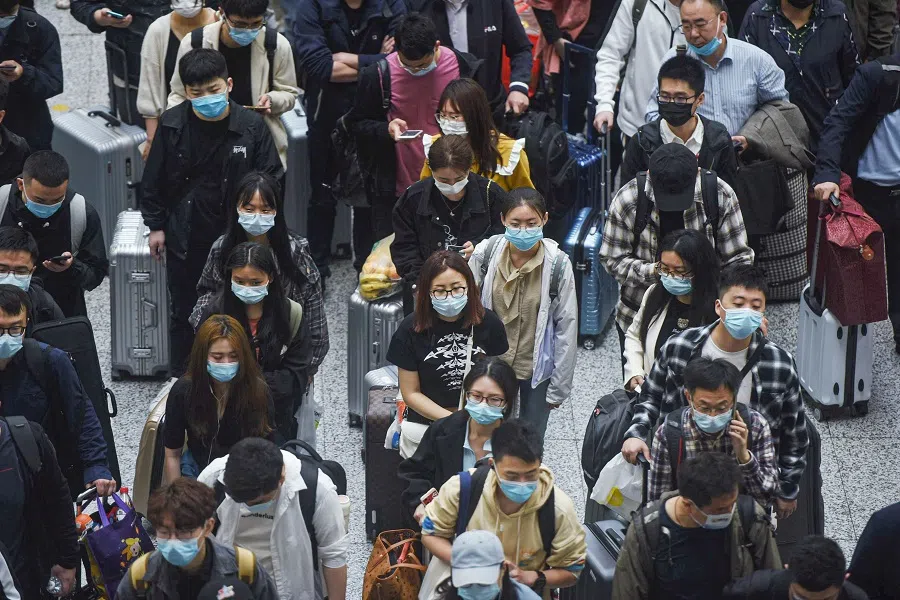Passengers prepare to board trains at Hangzhou East train station in Hangzhou, Zhejiang province, China on 30 April 2021. (STR/AFP)
