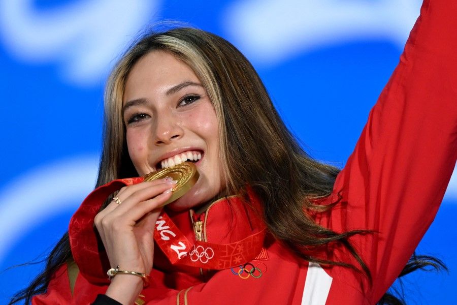 Gold medallist China's Gu Ailing Eileen celebrates on the podium during the freestyle skiing women's freeski big air victory ceremony at the Beijing Medals Plaza in Beijing on 8 February 2022. (Manan Vatsyayana/AFP)
