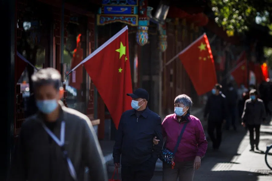 Chinese national flags in a street of an old neighbourhood as the city prepares for the 20th National Congress of the Communist Party of China, in Beijing, China, 11 October 2022. (Thomas Peter/Reuters)