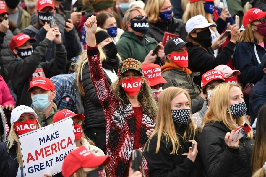 Supporters cheer before US President Donald Trump speaks during a campaign rally at Manchester-Boston Regional Airport in Londonderry, New Hampshire on 25 October 2020. (Mandel Ngan/AFP)