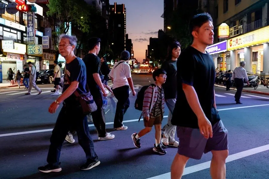 People cross the road near Ningxia Night Market in Taipei, Taiwan, 6 May 2026. (Ann Wang/Reuters)
