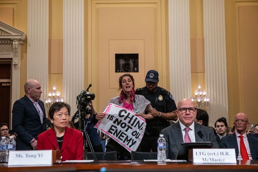 A demonstrator interrupts witness testimony to protest a House Select Committee on the Strategic Competition Between the United States and the Chinese Communist Party hearing in Washington, DC, US, on 28 February 2023. (Anna Rose Layden/Bloomberg)
