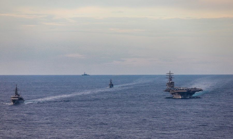 Japan Maritime Self-Defense Force training ships JS Kashima and JS Shimayuki conduct a passing exercise (PASSEX) with Nimitz-class nuclear-powered aircraft carrier USS Ronald Reagan in the South China Sea, 7 July 2020. (US Navy/Handout via REUTERS)
