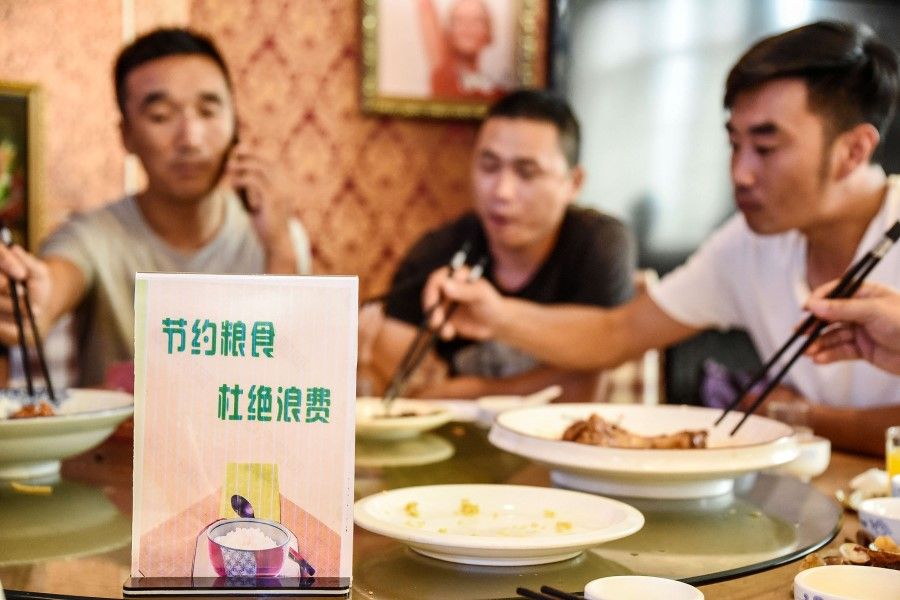 This file photo taken on 13 August 2020 shows a sign encouraging people not to waste food at a restaurant in Handan in China's northern Hebei province. President Xi Jinping started the "Operation Empty Plate" drive in mid-August 2020 to address what he called "shocking and distressing" waste, prompting a nationwide push to comply. (STR/AFP)