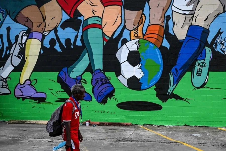 A man walks past a mural by artist Donkeeboy in downtown Houston, near the FIFA Fan Fest in Texas, on 10 June 2026, ahead of the 2026 FIFA World Cup.