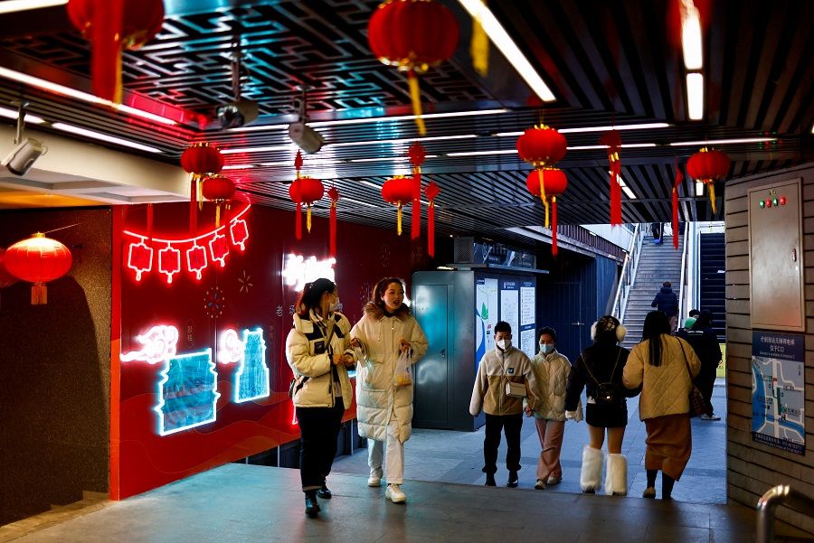 People walk past an underground area decorated with lanterns amid the Covid-19 outbreak in Beijing, China, 6 January 2023. (Tingshu Wang/Reuters)